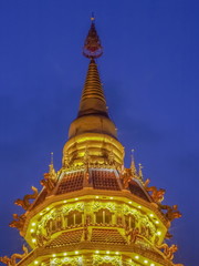 Beautiful Top of Pagoda chinest style decorate with lighting at night with cloudy sky background, Wat Huay Pla Kang, Chiang Rai, Thailand