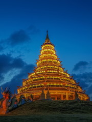 Beautiful Pagoda chinest style decorate with lighting at night with cloudy sky background, Wat Huay Pla Kang, Chiang Rai, Thailand