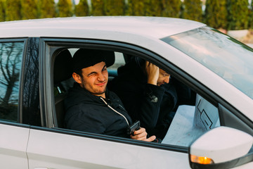 Thieves parked in an ally waiting while observing their target and loading their guns.