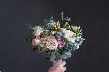 Bouquet of peach and pink roses on gray background. Nice mood