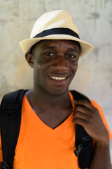 Face of young happy black African tourist man smiling