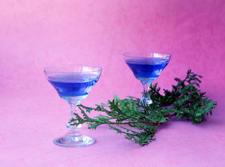 Blue curacao alcohol coctail on a pink background