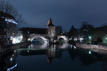 Nuremberg city, Germany - Schlayerturm medieval tower and Kettensteg (Chain Bridge) in night