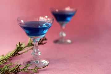 Blue curacao alcohol coctail on a pink background
