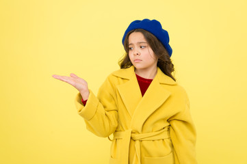 Place for ad advertisement. Child promoting something yellow background copy space. Girl show open palm. Advertising product. Look at this. Advertisement launching product. Advertisement concept