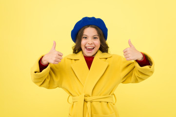 Child promoting something yellow background. Girl show thumbs up gesture. Advertising product. Look at this. Advertisement launching product. Advertisement concept. Place for ad advertisement