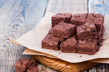 Pieces of freshly baked chocolate brownie on rustic wooden board