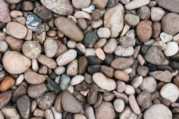 Beautiful background with sea stones. Colorful round colorful sea stones. Background for design.
