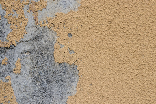 Yellow wall with grey paint peeling off texture in dark and light tone. Copy space. Background for text.