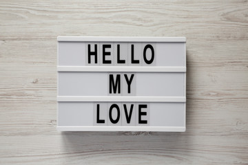 Modern board with text 'Hello my love' on a white wooden background, top view. Valentine's Day 14 February. Close-up.