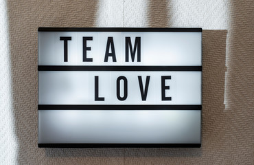 Message Team Love on illuminated board. Love concept with text.