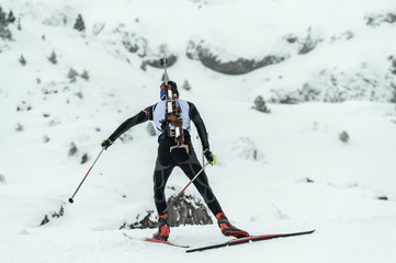 Winter sports. A participant in a biathlon competition, in a winter season in Spain, in a snowy...