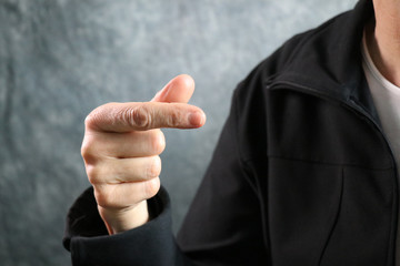 American Sign Language (ASL) letter G held in correct position next to body