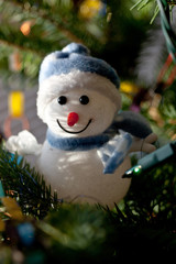A small snowman on the Christmas tree.