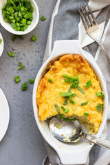 Potatoes casserole with cheese and green onion served with sour cream and mint. Vegetarian food. Copy space.