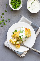 Potatoes casserole with cheese and green onion served with sour cream and mint. Vegetarian food. Copy space.