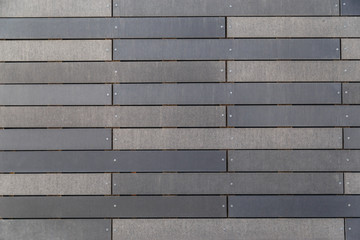 Contemporary facade building with long tiles