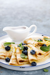 Sweet pancakes wrapped with fresh berries, crepes with blueberry