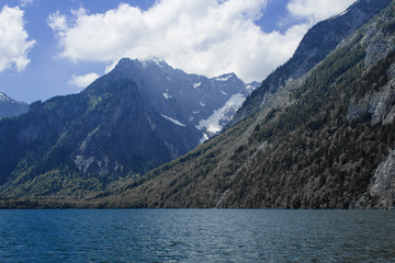 The beautiful view of the mountains with lake and meadow