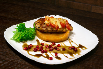  meat dish. Steak with mashed potatoes, greens, soy sauce and pomegranate seeds