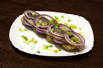 herring with boiled potatoes and fresh onions on a plate