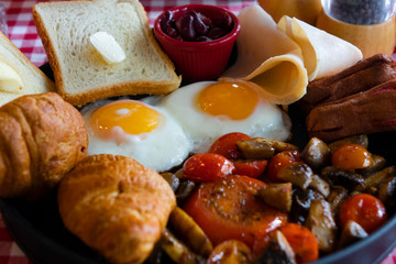 breakfast with fried eggs, coffee, juice and fresh fruits on wooden table