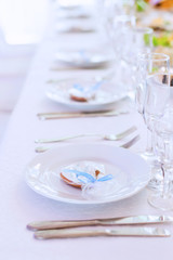 festive table with white plates and cutlery