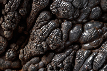 Macro mineral Hematite stone on a white background close-up