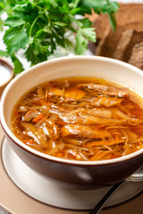 Traditional Russian sauerkraut soup Shchi in bowl on rustic wooden background. Selective focus.