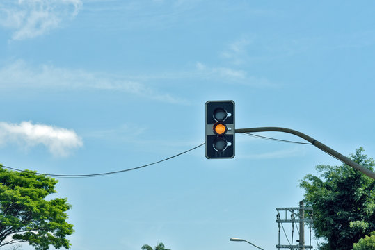 Yellow traffic light under blue sky