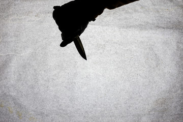 The knife in the hand of men who is ready to attack his victim. Breaking the law and crime. Attack...