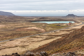 Mountain view of the blue lake and the building, Krysuvík, Iceland