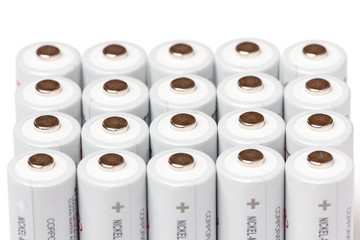 AA batteries are close to each other. Close-up of white batteries on a white background. Battery technology