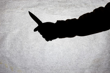 The knife in the hand of men who is ready to attack his victim. Breaking the law and crime. Attack...