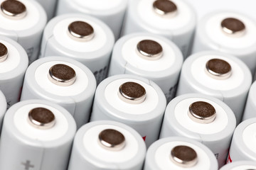 AA batteries are close to each other. Close-up of white batteries on a white background. Battery technology