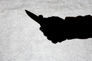 The knife in the hand of men who is ready to attack his victim. Breaking the law and crime. Attack...