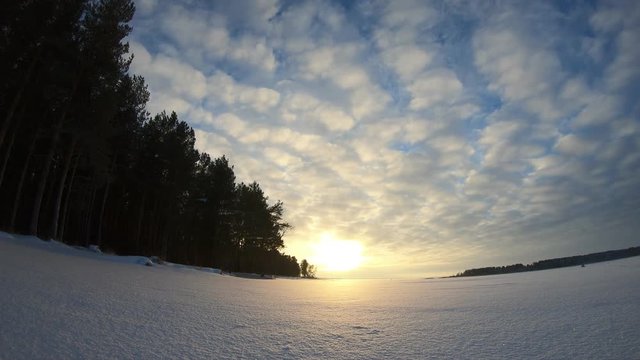 Timelapse clouds in winter over the lake in winter
