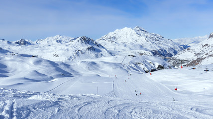 Downhill skiing, snowboarding slopes, off piste trails, in French winter resort of Val d’Isere, Alps , with panorama of mountain snowy peaks and valleys . - obrazy, fototapety, plakaty