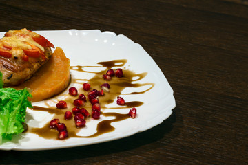 copy spaсe, meat dish. Steak with mashed potatoes, greens, soy sauce and pomegranate seeds