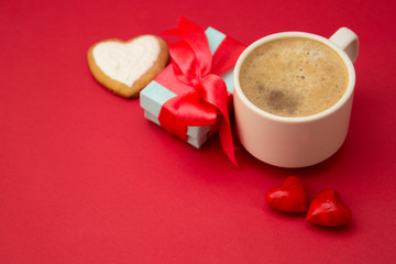 Good morning with hot coffee, lattee, capuccino drink ored background with red heart for your love, valentine's day concept. Gift boxes, surprise.