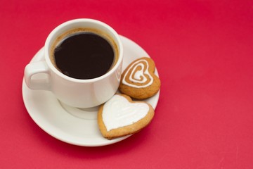 Love, Valentine's Day. Cup of coffee and heart shaped cookies, biscuits. Top view. Red background.