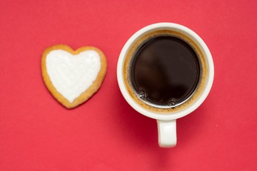 Love, Valentine's Day. Cup of coffee and heart shaped cookies, biscuits. Top view. Red background.