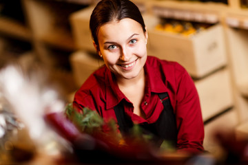 Photo of young woman with bottle in hands in wine shop