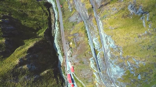 An aerial shot of a train going around the "Nariz del Diablo" or  Devil's Nose in Alaus&radic;&ne;, Chimborazo Province, Ecuador. The Devil's Nose is one of the world's most picturesque and dangerous railways.