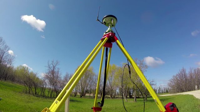 Timelapse of Leica GNSS (GPS) base station for land surveying with clouds moving by, on a summer day in St. Francis Xavier Manitoba Canada.