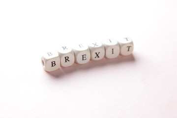 Word Brexit, written on wooden cube. Exit the UK with the European Union. Concept