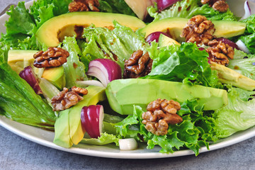 Healthy salad with avocado, blue onion and walnuts. Keto Salad Superfoods Concept proper diet.