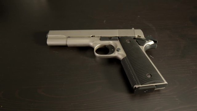 Cocked pistol on table, wide center shot