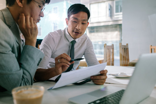 Business Professionals Discussing Over Some Paperwork