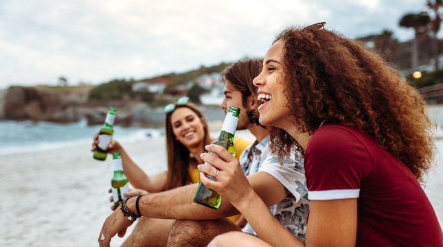 Woman having party with friends at beach